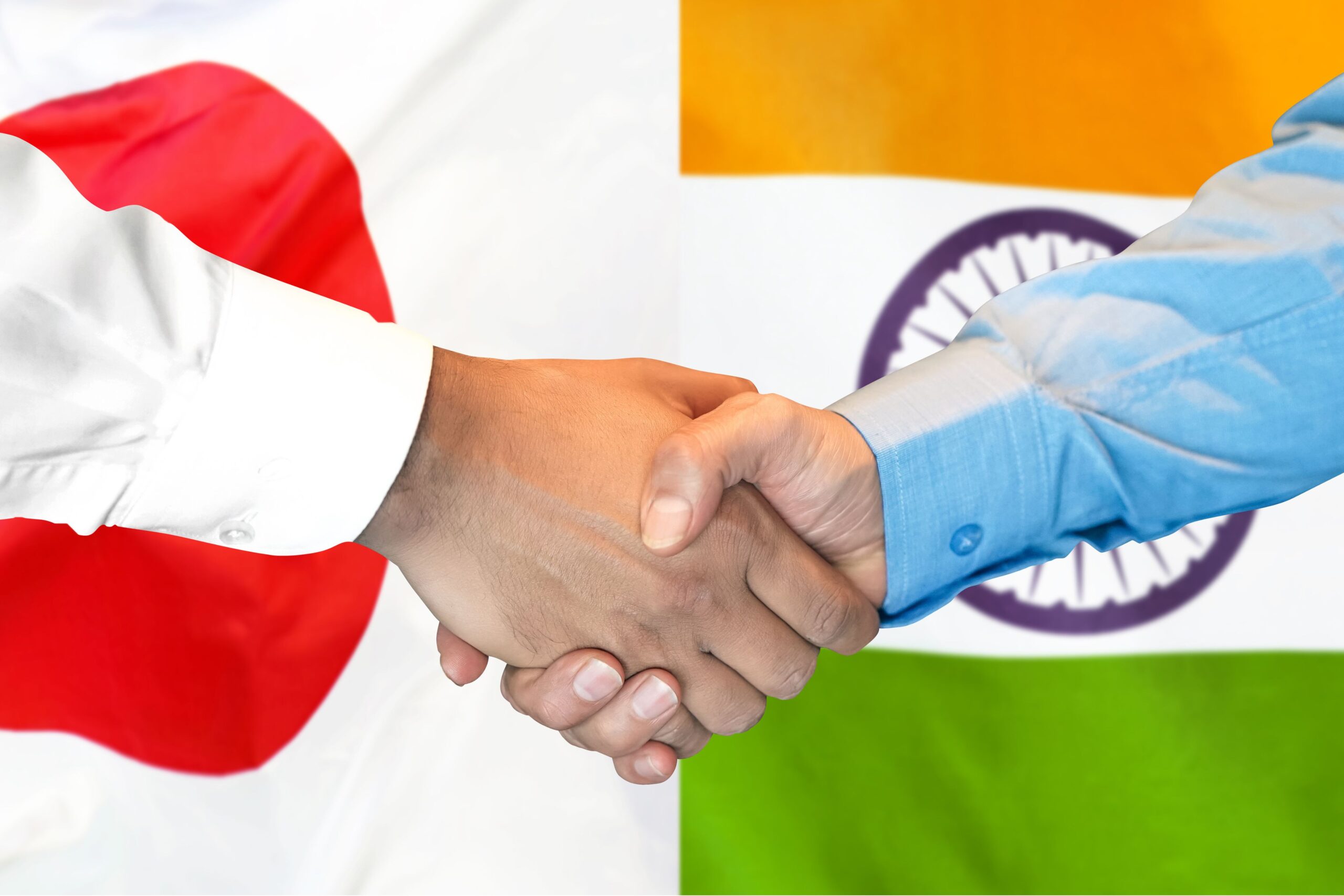 Japan India partnership handshake with national flags representing technology cooperation and investment collaboration