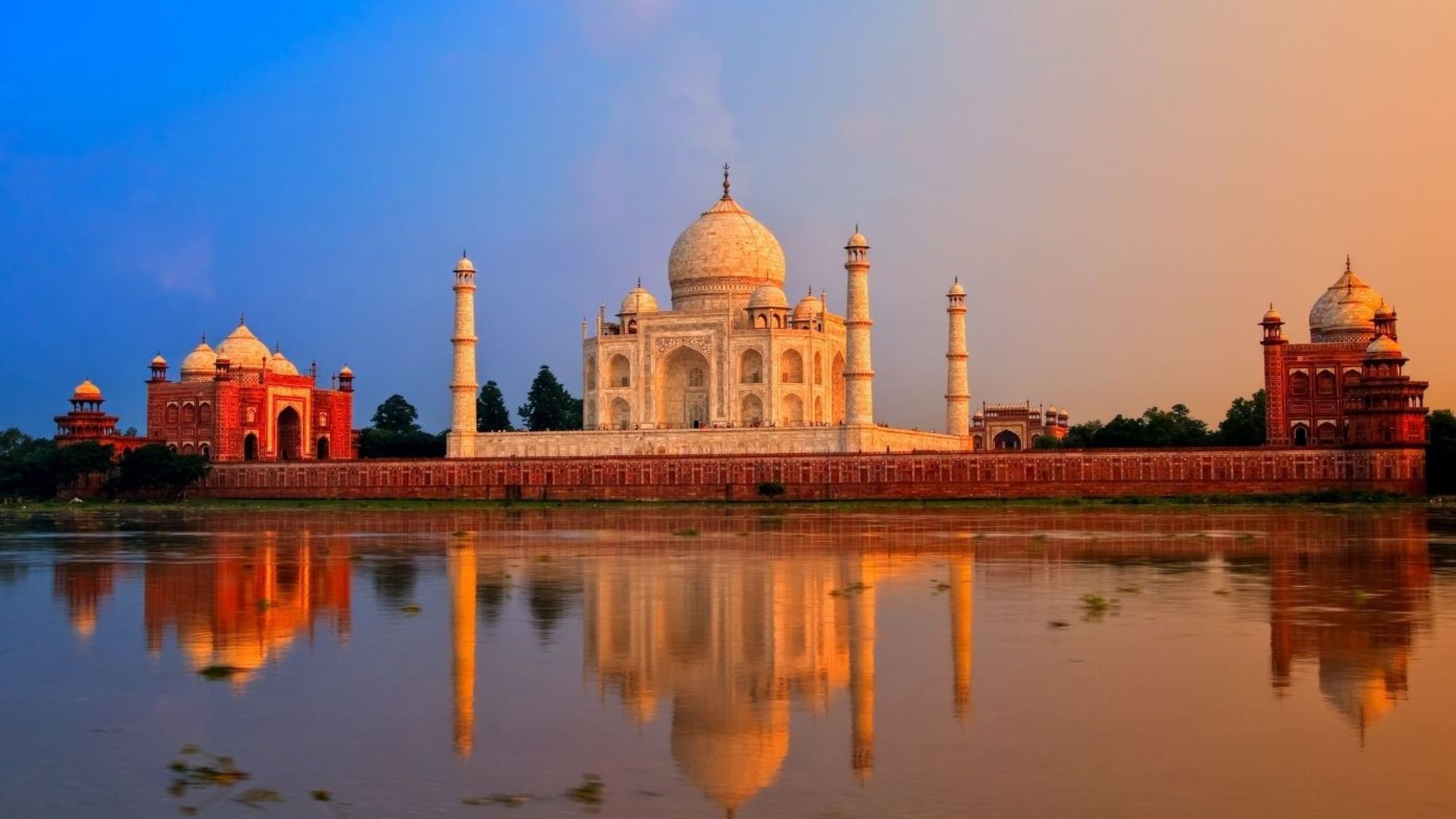 Taj Mahal at sunrise reflected in water, a UNESCO monument central to heritage travel in India