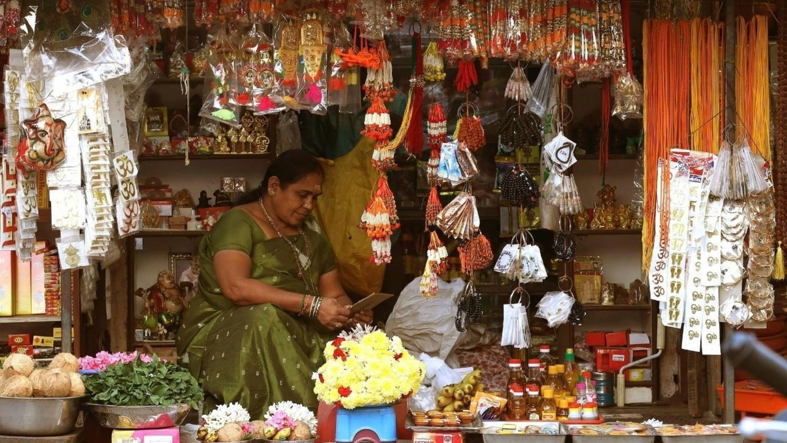 Busy festive market in India during Eid al-Adha with shoppers purchasing clothing and food for the celebration