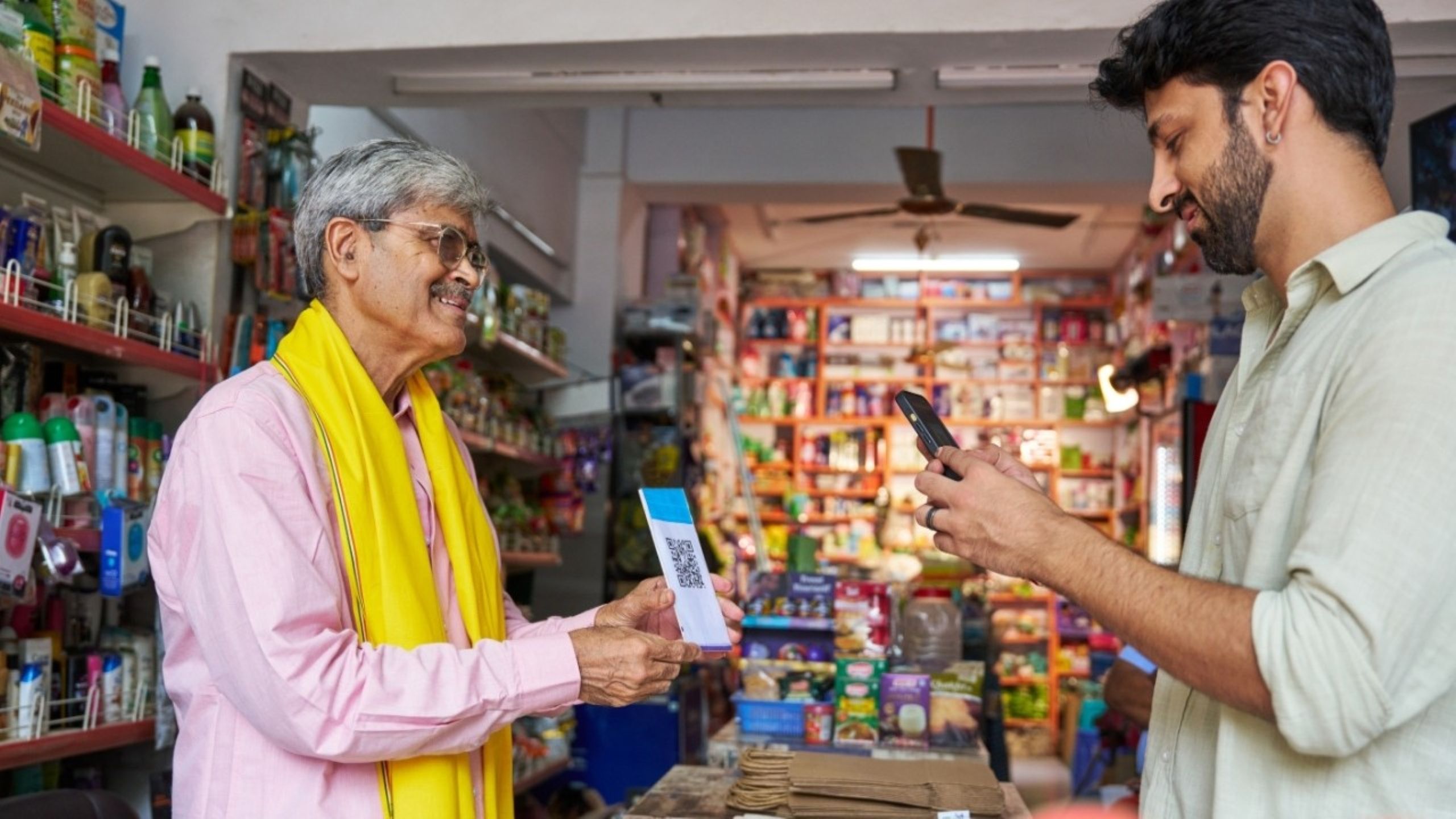 Indian street vendor accepting UPI digital payment via QR code scan representing India's fintech revolution in 2026