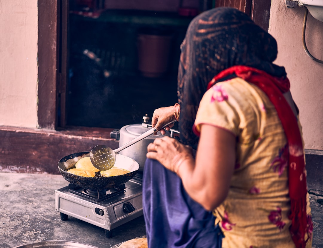 A woman prepares a traditional ragi dosa, one of the most popular naturally gluten-free breakfast dishes.