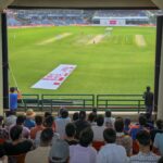 An Indian cricket fan in blue jersey celebrating a boundary during the India vs England ODI series