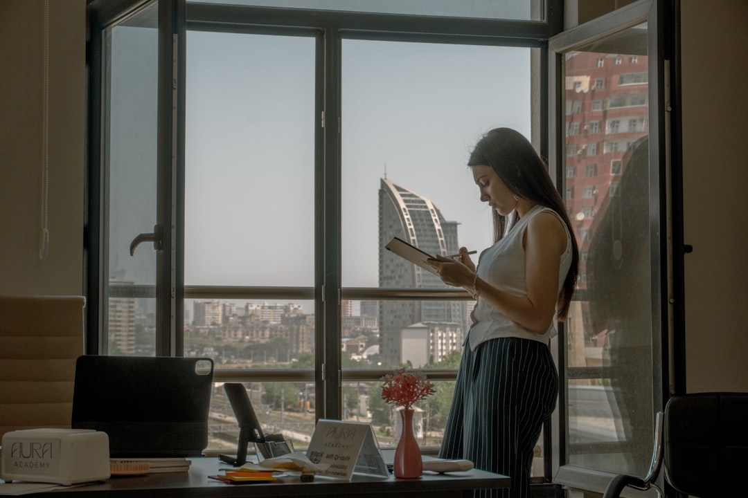 A focused Indian professional woman reviewing her NPS tier II account investment documents at a desk