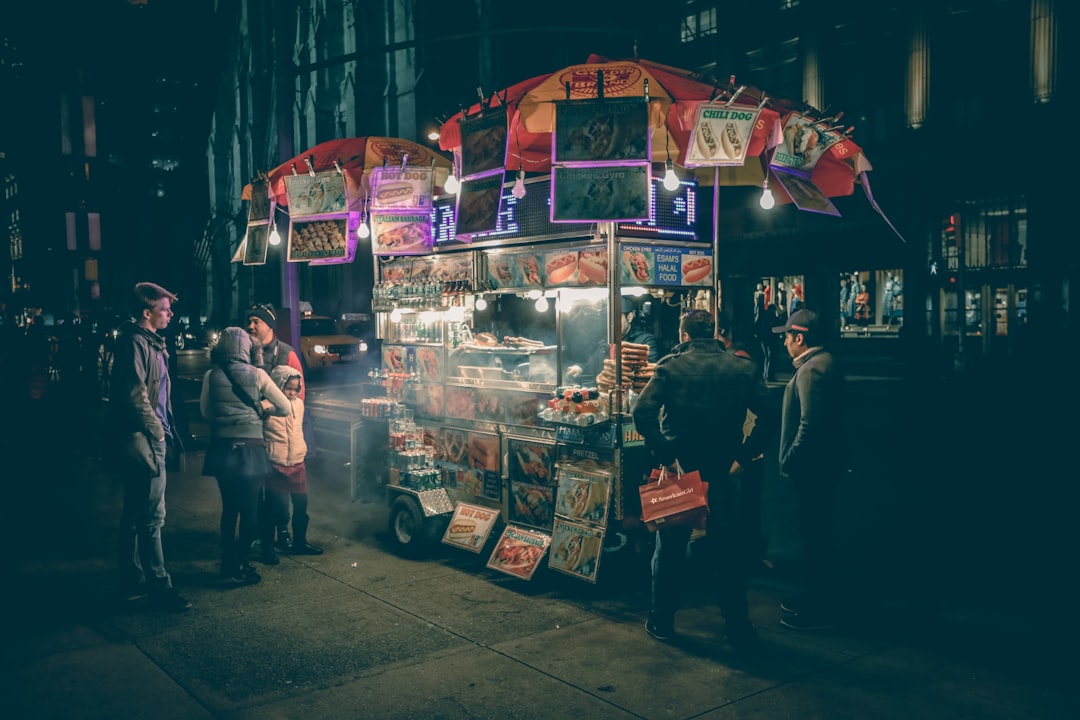 A smiling street vendor fries golden pakoras at a busy stall, capturing the joy of monsoon street food in Delhi