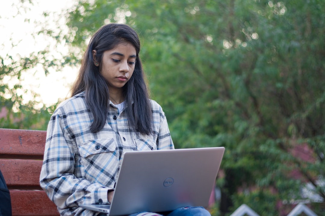 A young Indian woman studies on her laptop, representing India's demographic dividend generation preparing for the future.