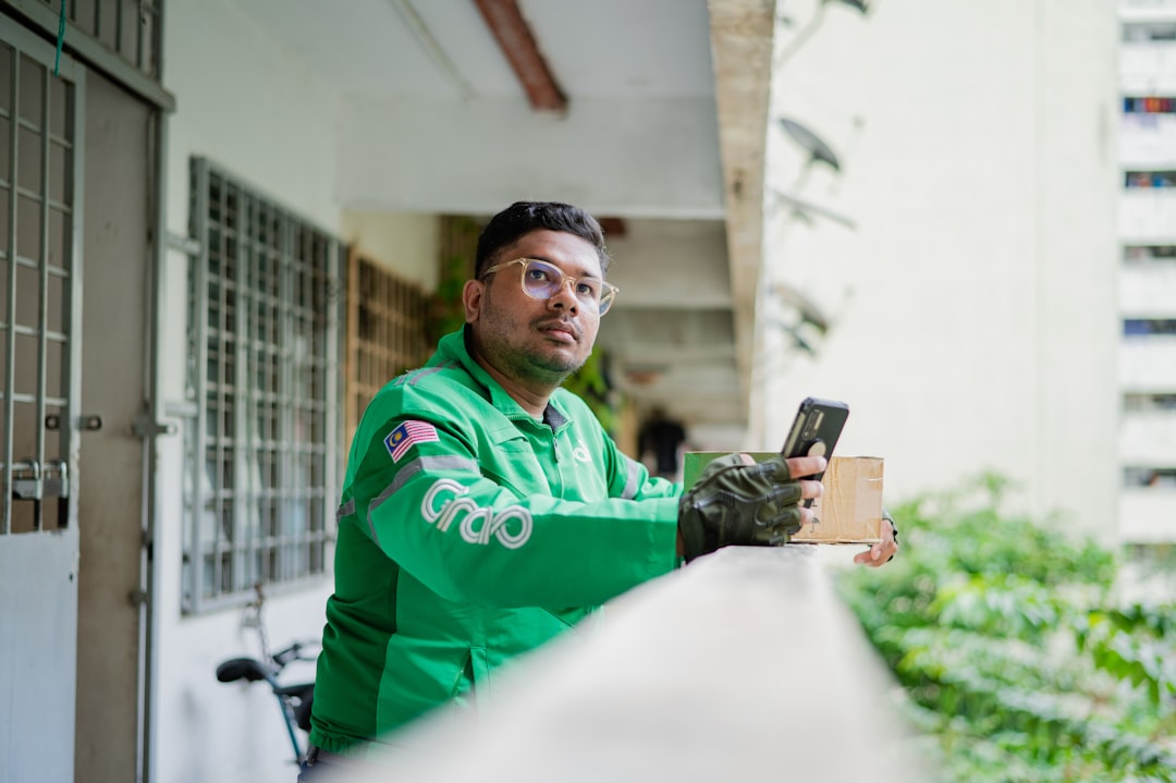 A young Indian man browses a food delivery platform on his smartphone, reflecting the surge in food delivery demand.
