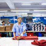 An Indian-origin entrepreneur reviews fabric samples ahead of the festive procurement season in a Singapore textile shop