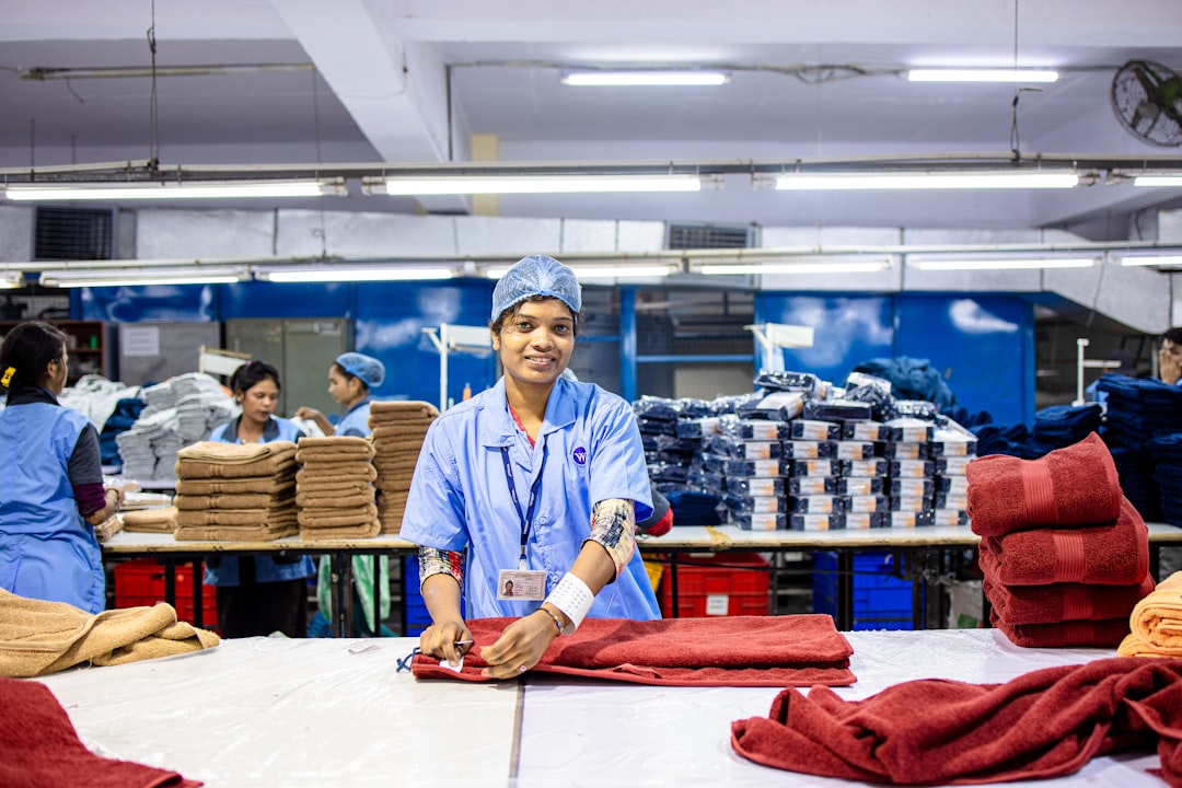 An Indian-origin entrepreneur reviews fabric samples ahead of the festive procurement season in a Singapore textile shop