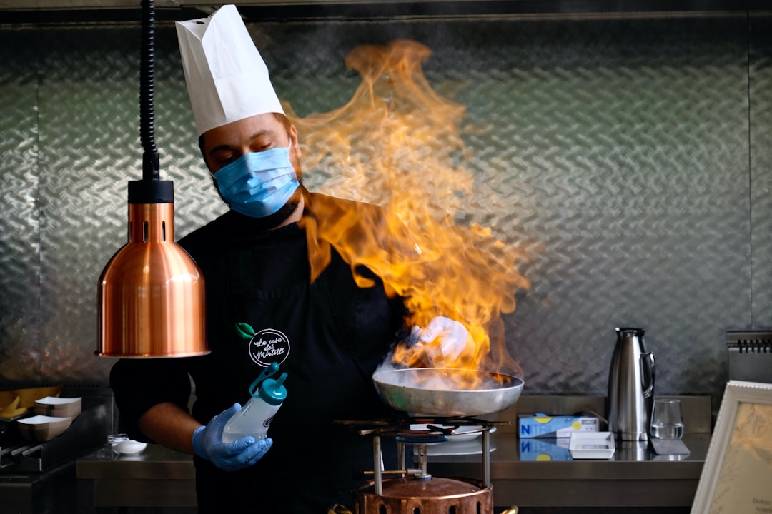 An Indian-origin chef carefully plates a monsoon flavours curry dish at a modern Singapore restaurant
