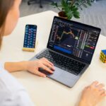 A focused Indian woman reviews her equity portfolio on a laptop before the festive season rally begins