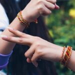 A sister ties a rakhi on her brother's wrist during Raksha Bandhan gifting ceremonies in India