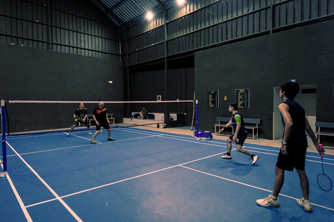 An Indian badminton player practices footwork drills on an indoor court during the September preparation phase.