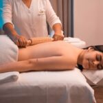 A therapist performs a traditional Shirodhara treatment on a guest at one of the heritage Kerala retreats during Onam season