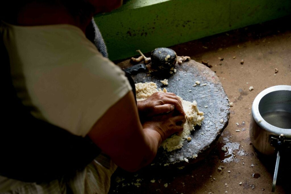 Woman preparing fermented foods batter in an Indian kitchen